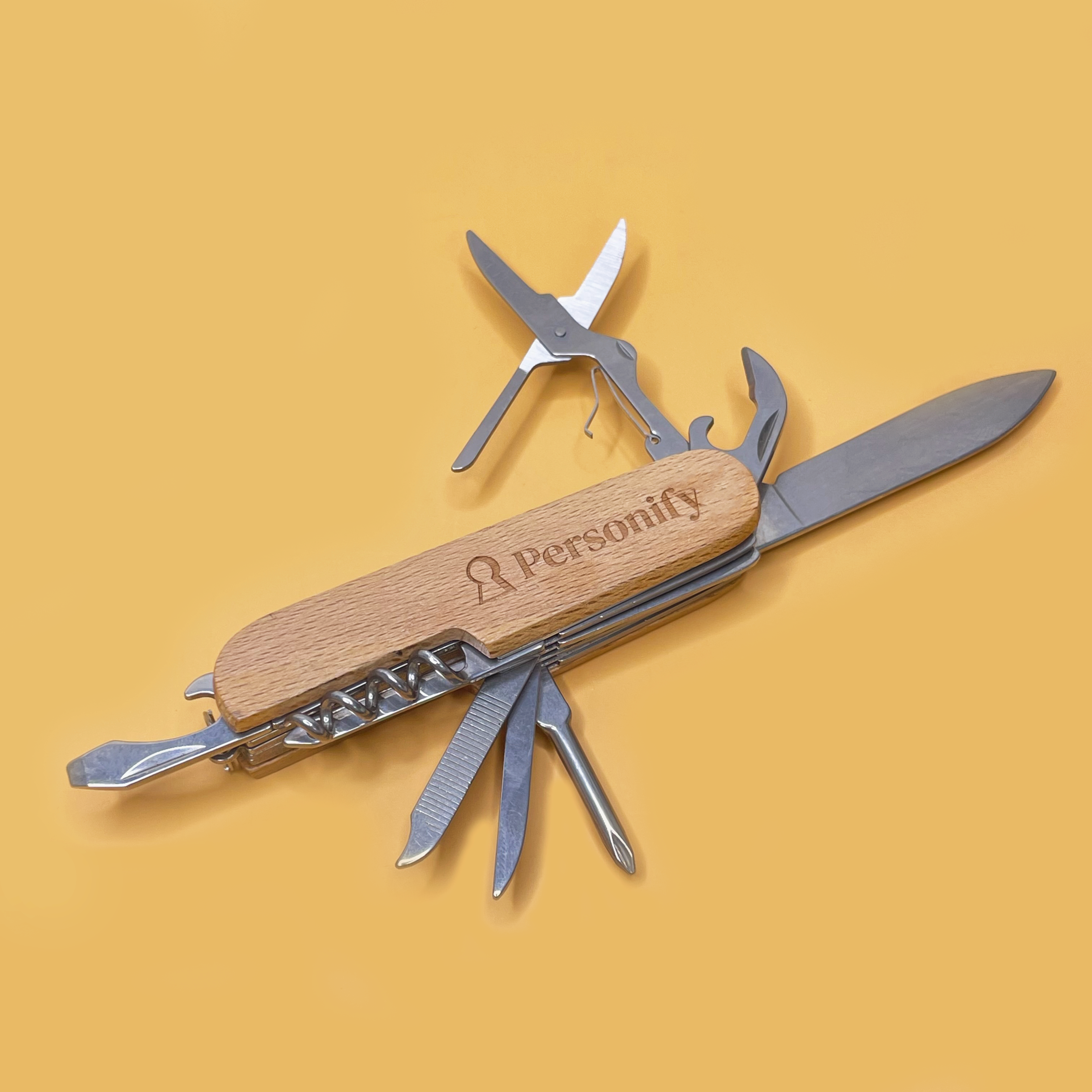 Multitool with wooden handle and 'Personify' branding on a yellow background