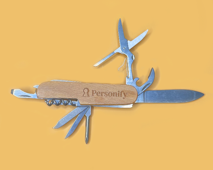 Multitool with wooden handle and 'Personify' branding on a yellow background