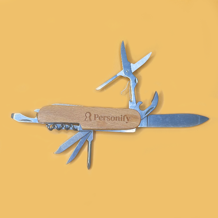 Multitool with wooden handle and 'Personify' branding on a yellow background