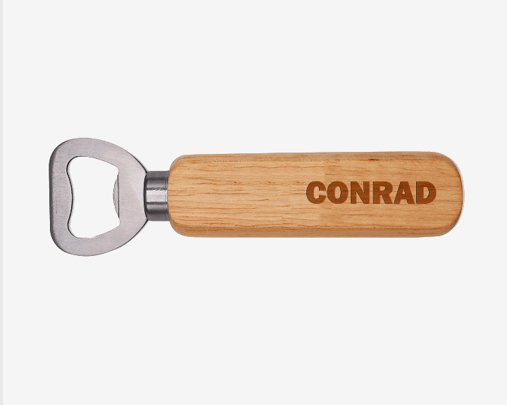 Wooden bottle opener with 'CONRAD' engraving on a white background