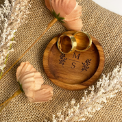 Wooden ring box with 'MS' engraving on a burlap background