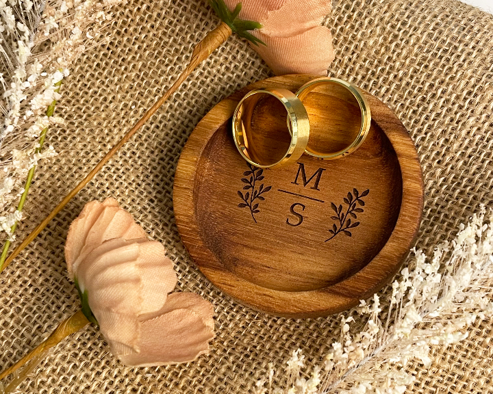 Wooden ring box with 'MS' engraving on a burlap background